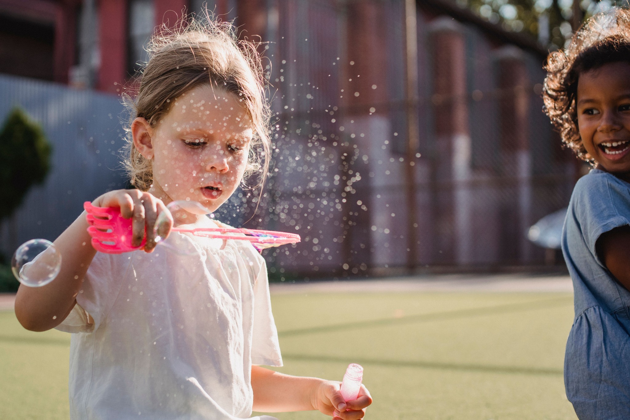 Children playing with bubbles outdoors